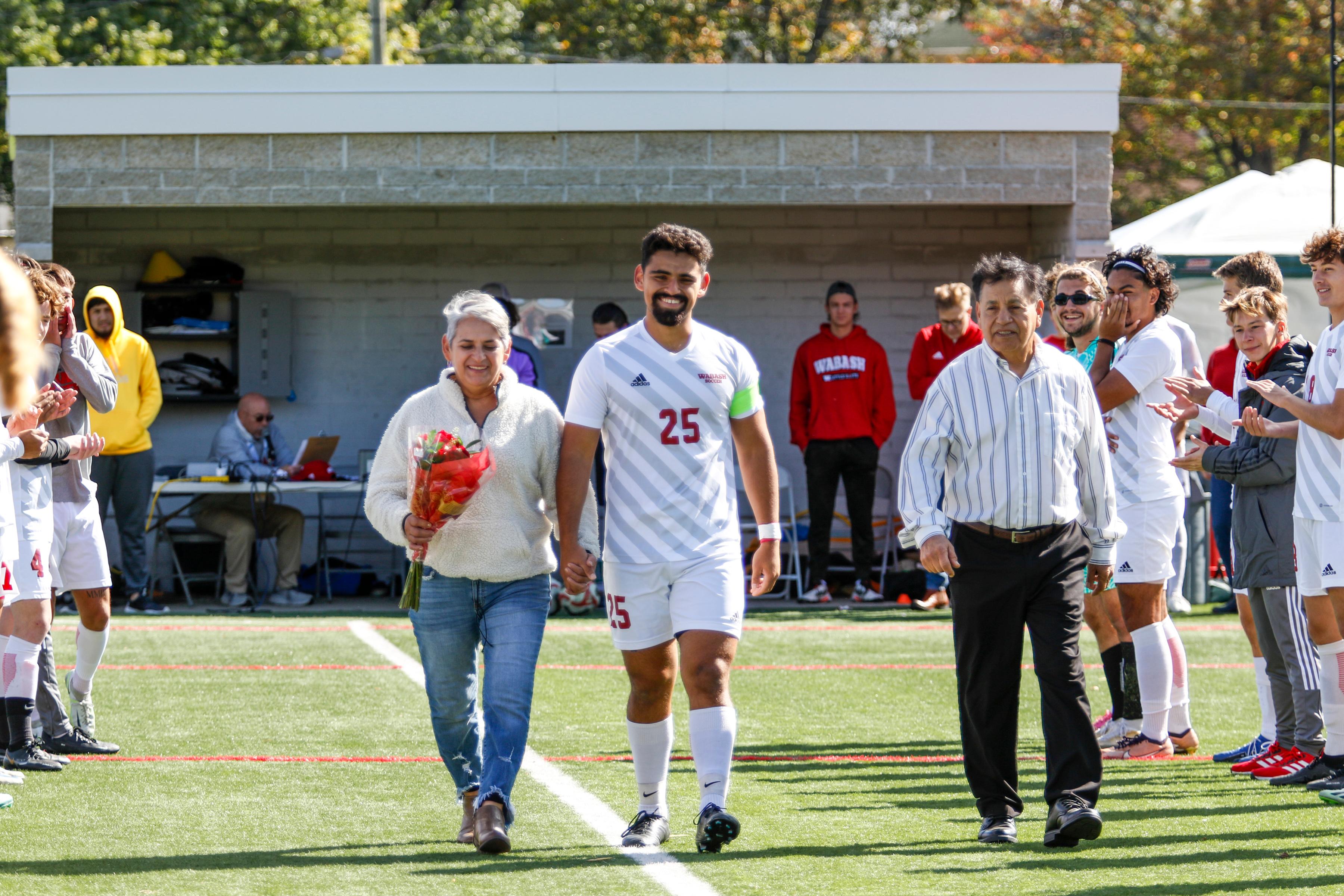 Garcia celebrates Senior Day last fall with his family ahead of a home win over Hiram College. 